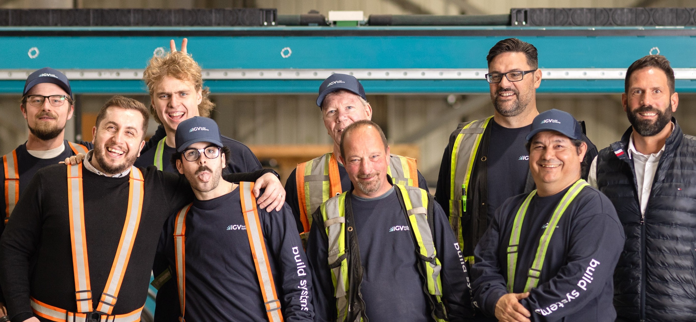The IGV Build Systems team together on the manufacturing floor
